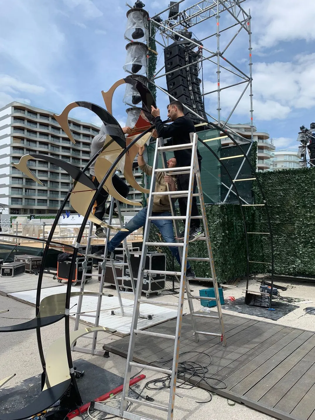 Outdoor Indoor crew installing a metal structure on a terrace
